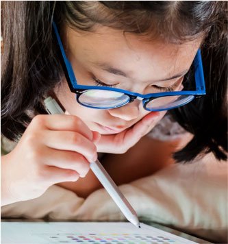 Girl with glasses selecting a color on tablet with tablet pen
