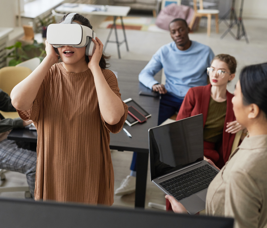 User research team focusing on a young woman wearing a VR headset in the foreground.